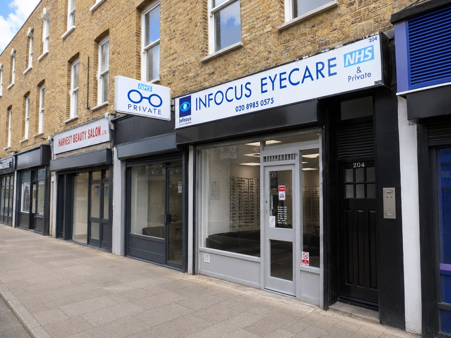 The Infocus Eyecare shopfront at 204 Well Street, Hackney, next to Harvest Beauty Salon